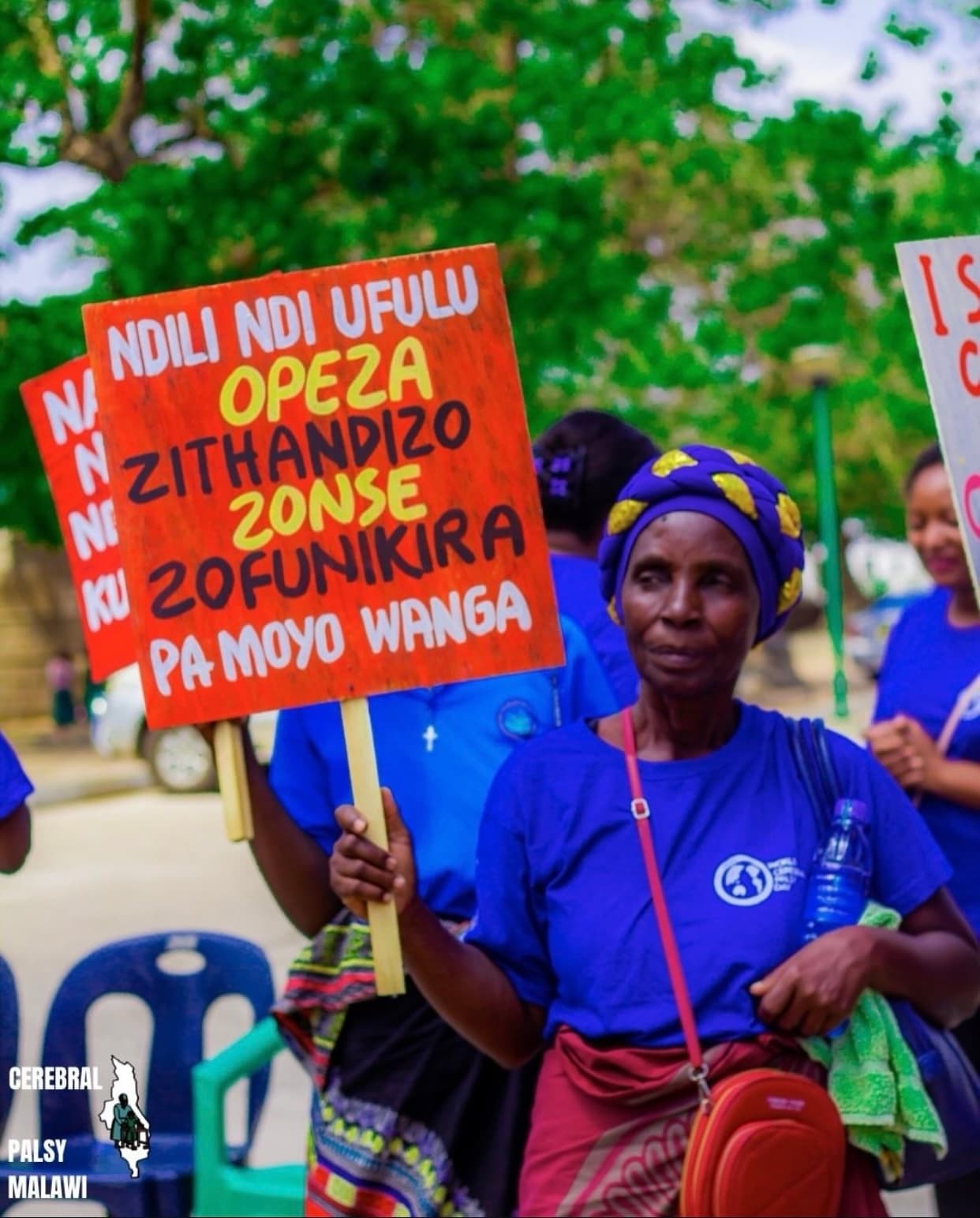 A caregiver holding an awareness placard at a Patsogolo CP Foundation event