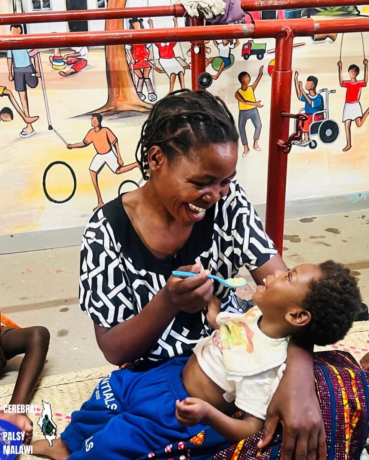 A caregiver with a child at a Patsogolo CP Foundation clinic